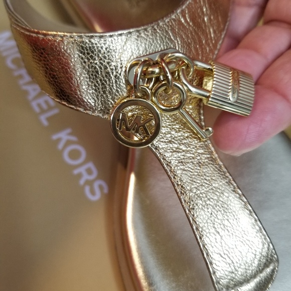 Michael Kors Shoes - New 6.5 Michael Kors gold charm Leather Sandal